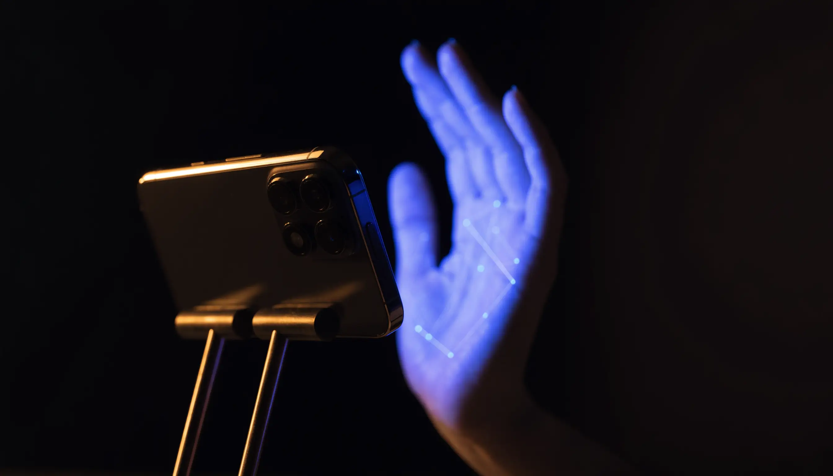 A hand holding a smartphone mid-capture