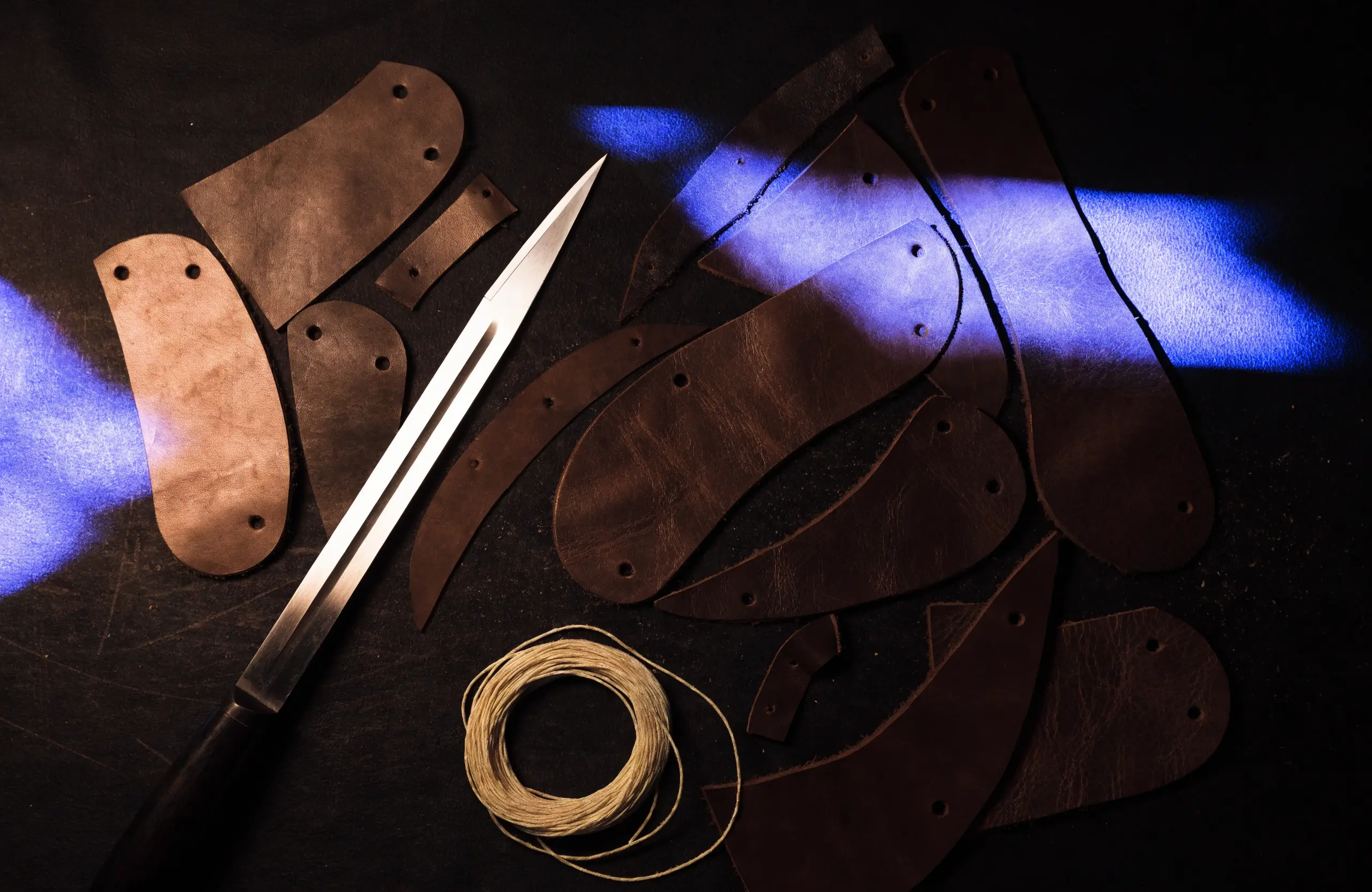 A craftsperson shaping leather by hand in a workshop