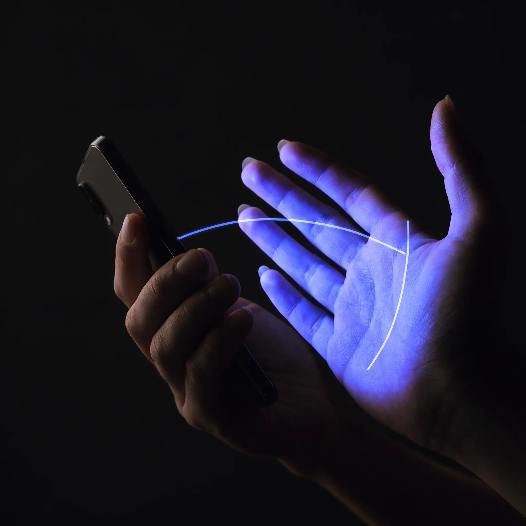 A hand capturing the other open hand with a smartphone and a blue scan line