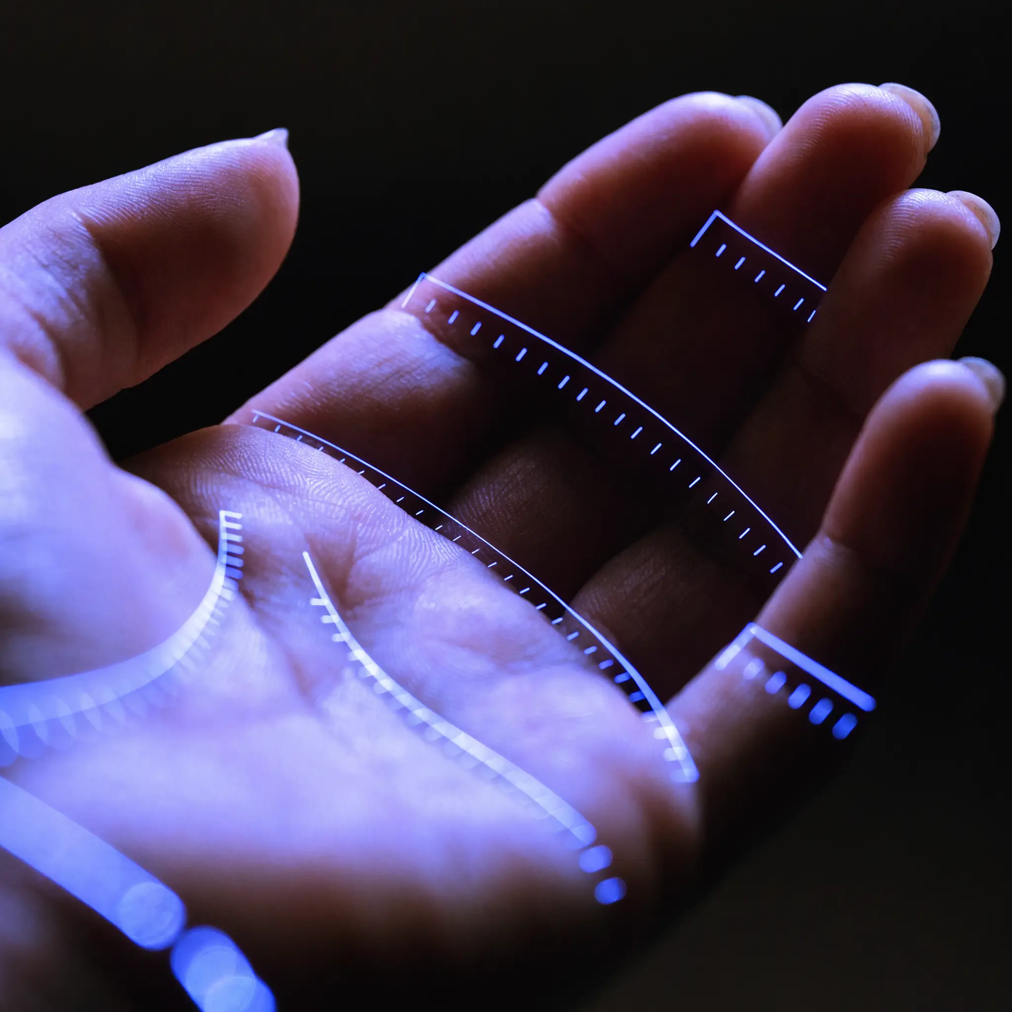 An open hand measured with glowing blue caliper dimension lines